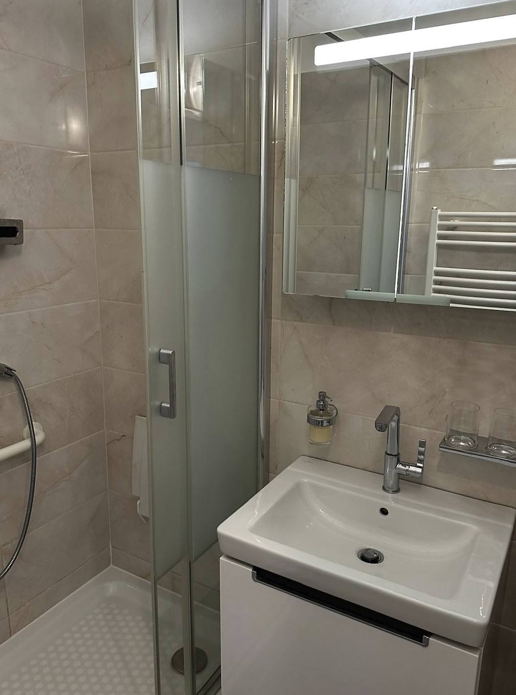 Badezimmer mit Waschtisch, Spiegelschrank und Dusche
